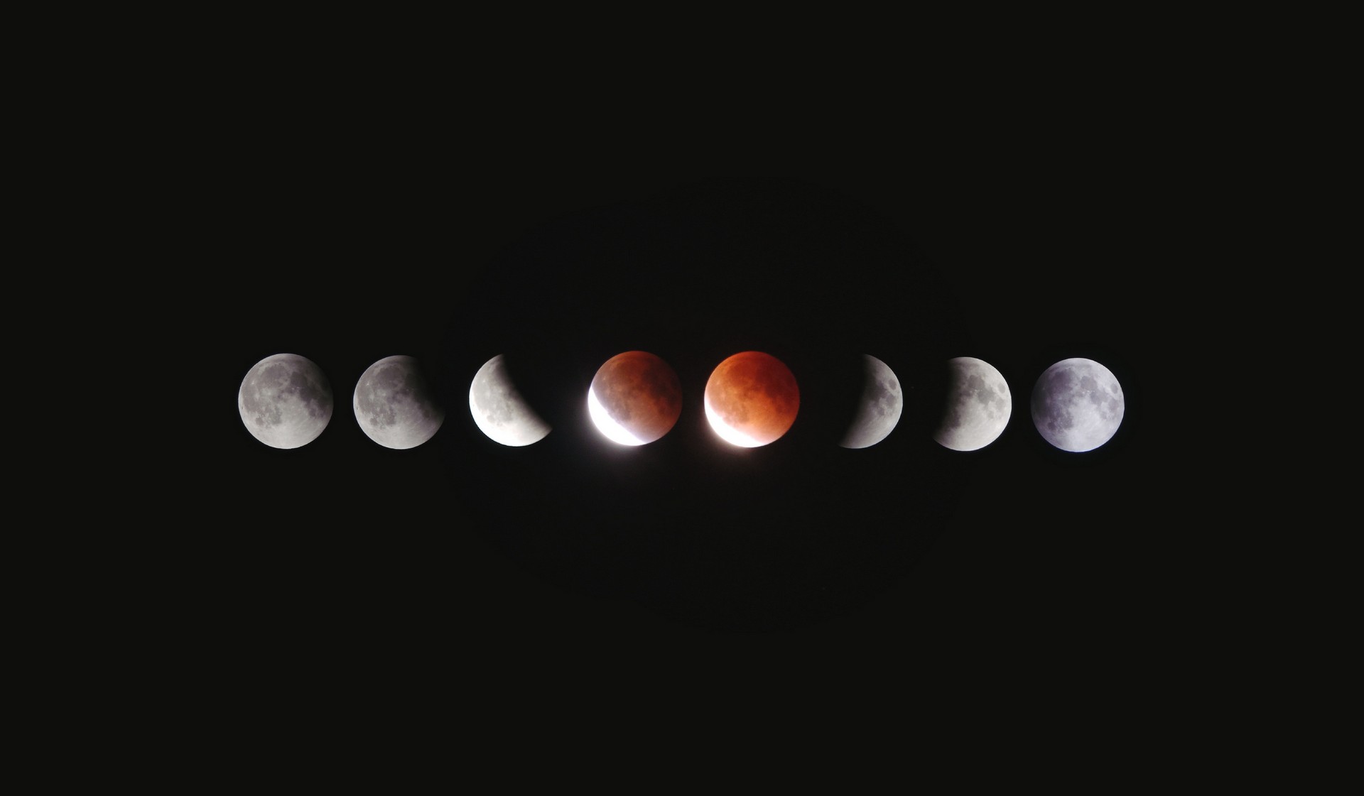 Various phases of the moon against a black sky with planets.
